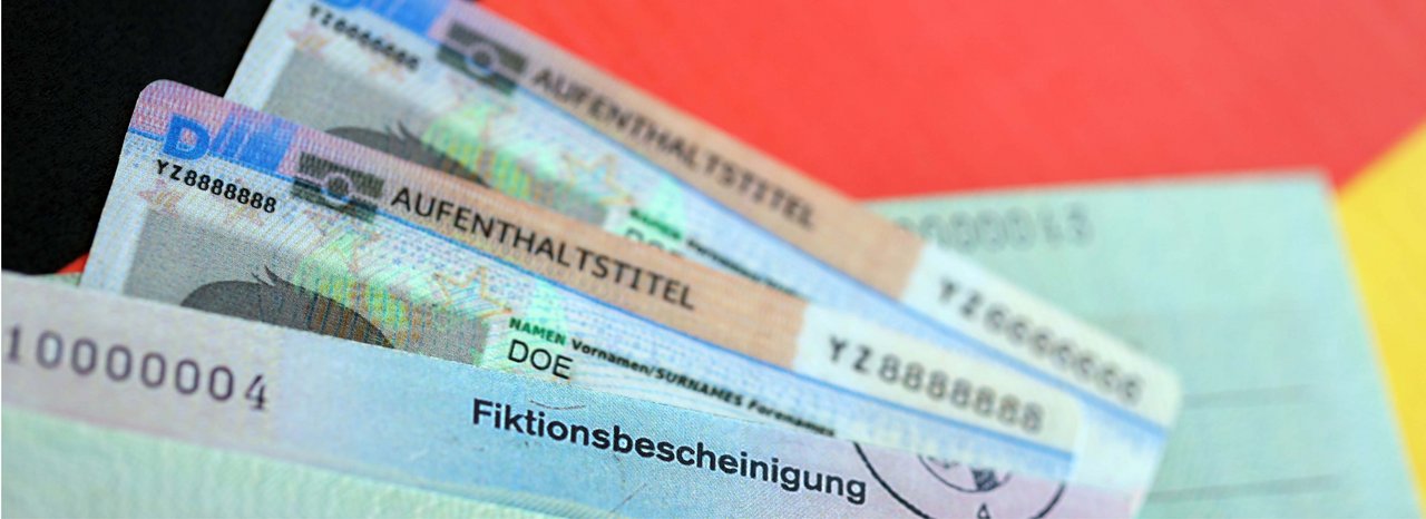 German Permanent resident card and temporary document lies on Germany flag