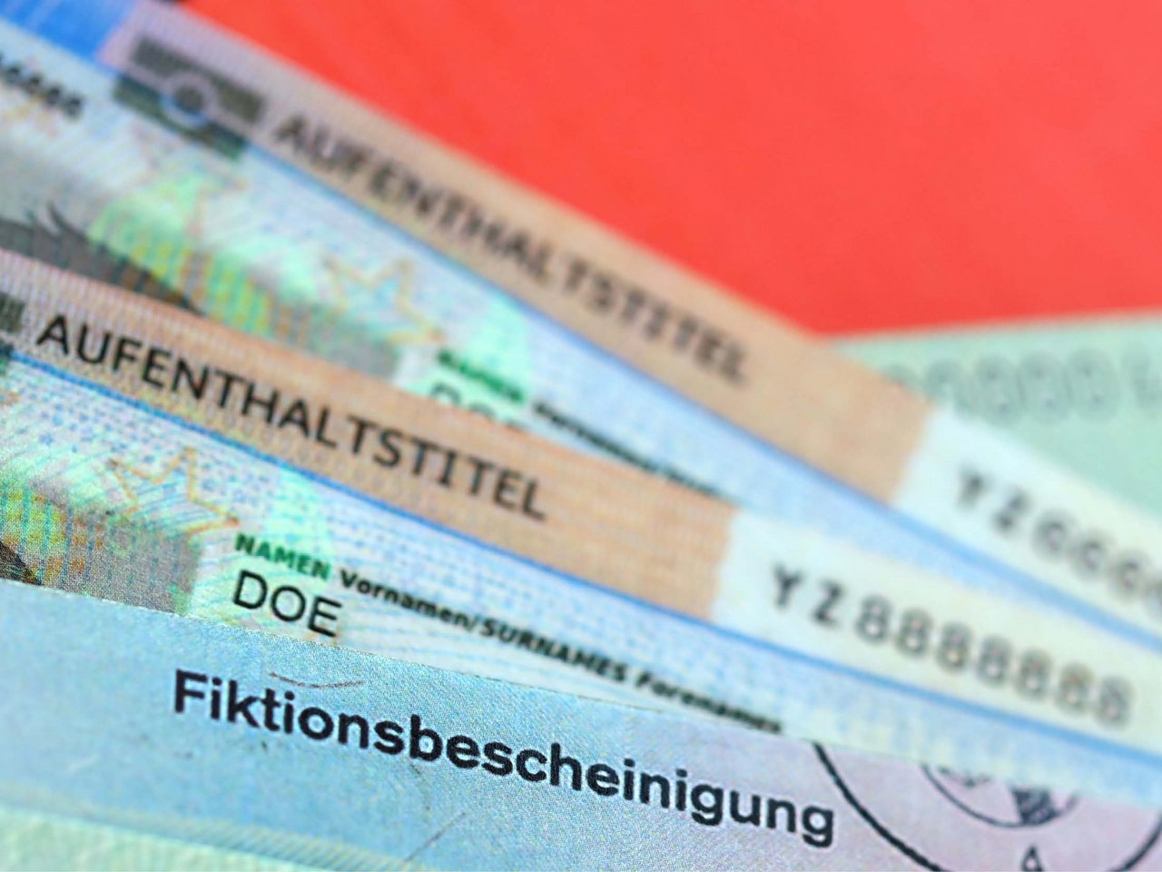 German Permanent resident card and temporary document lies on Germany flag