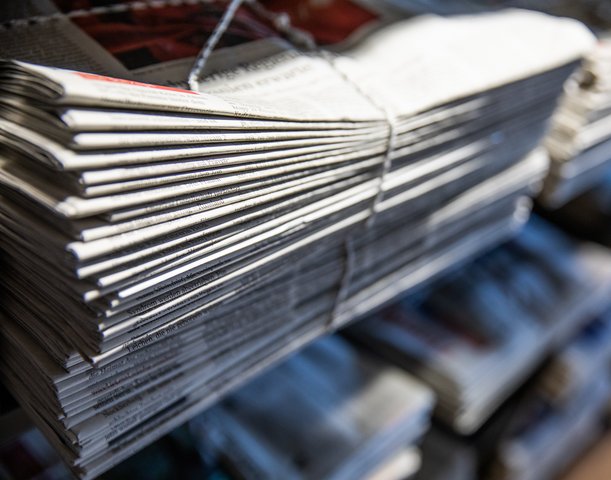 A shelf with newspapers.